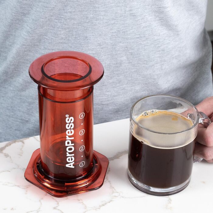 AeroPress Clear Coffee Press – 3-in-1 Coffee Machine combines French Press, Pour Over & Espresso – Full-bodied coffee without bitterness – Portable mini coffee machine for travel, Transparent (Standard, Red)